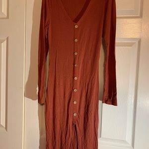 Long sleeved knee length tight fitting dress.